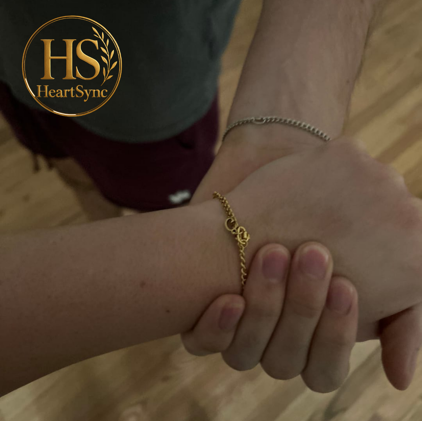 Two people wearing Heartsync permanent bracelets, showcasing connection and modern jewelry style.