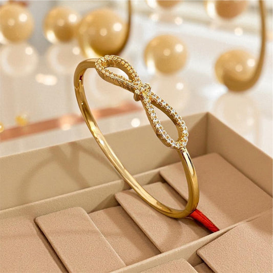 HeartSync’s Eternal Grace Bangle – Gold Infinity Bow Bracelet